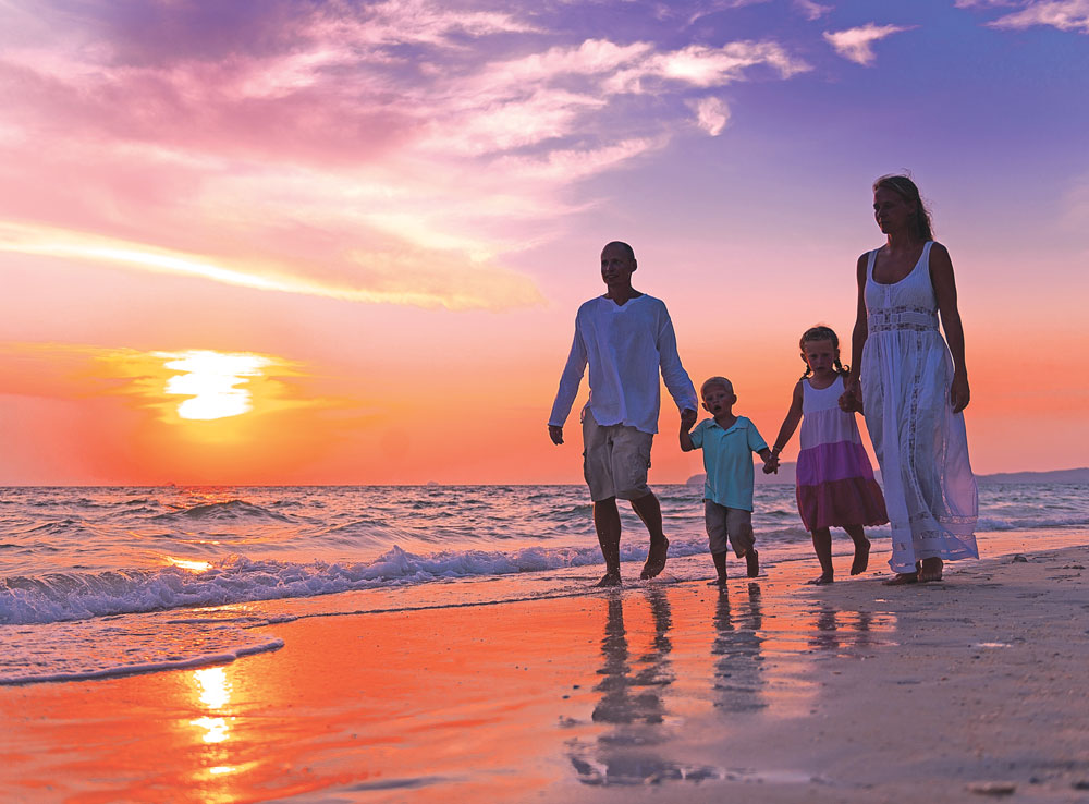 A family walking on the beach in Carlsbad